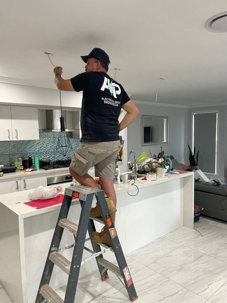 AP Electrical Group staff installing up ceiling down lights